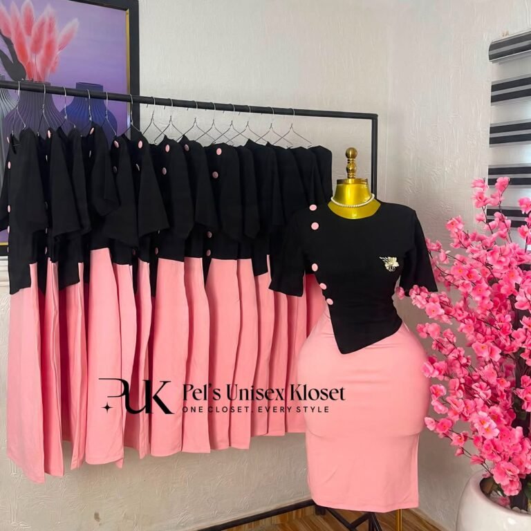 Black asymmetric short-sleeve top with pink buttons paired with a pink pencil skirt