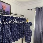 Navy blue and white polka dot corporate dress with a white Peter Pan collar and brooch