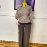 Brown and white striped peplum shirt with a tie waist and gathered sleeves, worn with matching brown wide-leg trousers