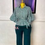 Green and white striped peplum shirt with tie waist paired with dark green wide-leg trousers