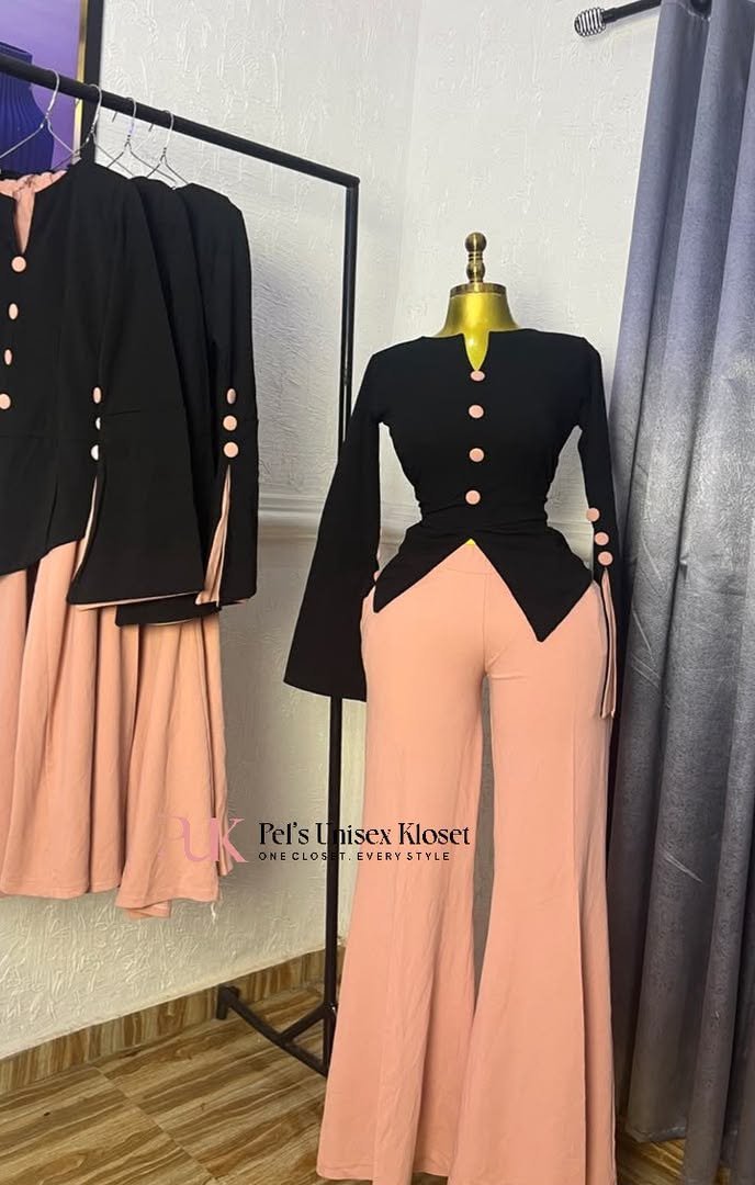 Black long-sleeve peplum top with peach buttons paired with peach flared trousers