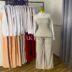 Nude strapless wide-leg jumpsuit worn under a white collared long-sleeve shirt - additional view