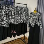 Black and white zebra print long-sleeve peplum top with black flared trousers