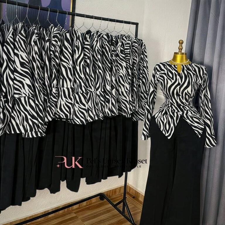 Black and white zebra print long-sleeve peplum top with black flared trousers