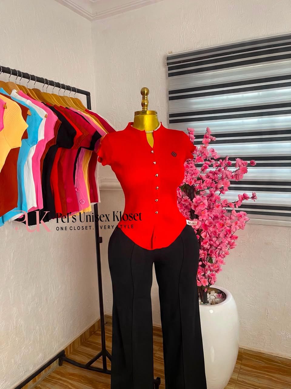 Cap-sleeve knit top and tailored trousers Red cap-sleeve button-front knit top styled with black tailored trousers
